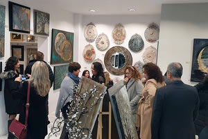 Η αστυνομικός από το Hράκλειο Μαρία Καφτάκη με τα έργα της, τα οποία εκτίθενται στο πλαίσιο της δεύτερης προσωπικής της έκθεσης που γίνεται στην πόλη.