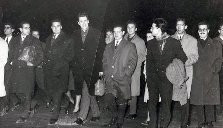 ΜΙΚΗΣ ΘΕΟΔΩΡΑΚΗΣ: Δεξιά του Μίκη, ο Πρόεδρος του Συλλόγου Γιάννης Αλεξανδράκης, δίπλα του εγώ με τα γυαλάκια, κρατώντας το σακ-βουαγιάζ του Μίκη και τέλος ο αξέχαστος σύντροφος και φίλος μας Σήφης Καμάρης. Αριστερά του Μίκη οι Μανώλης Αθουσάκης, Βασίλης Ζεβελάκης , Βασίλης Χαραλαμπίδης, ο αξέχαστος φίλος και σύντροφός μας Μιχάλης Φαρσάρης και τελευταίος δεξιά ο ψυχίατρος Μανώλης Μυλωνάκης από τα στελέχη της Νεολαίας της ΕΔΑ και των Λαμπράκηδων.