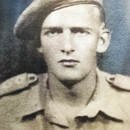 Στην κάτω πλευρά της φωτογραφίας αναγράφεται: Άντερς Λάσσεν, Ταγματάρχης Άγγλος εκ Δανίας. Αρχηγός σαμποτέρ κατά την πυρπόλησιν αεροδρομίου Καστελλίου τον Ιούλιον 1943 